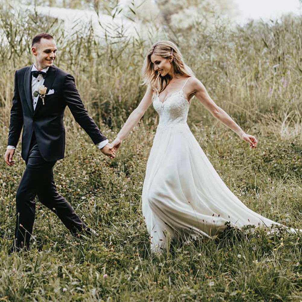 Bride wearing the Cupocupa A-line dress while walking outdoors