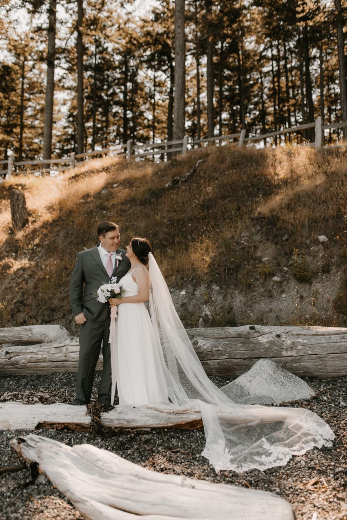Bride and groom photographed in a forest setting