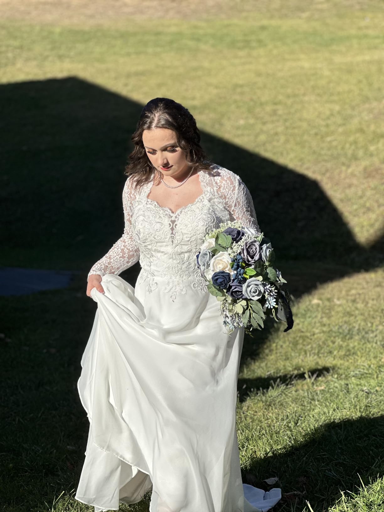 Bride holding a bouquet in natural sunlight